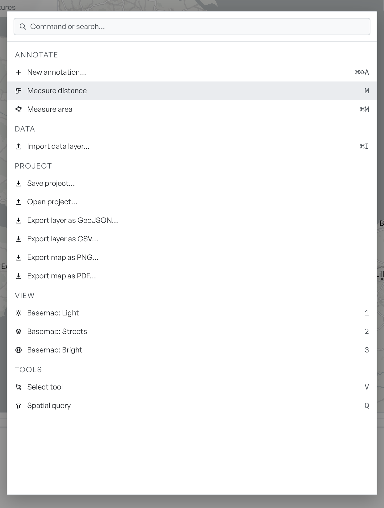 The command palette listing import, export, basemap and spatial query commands, each with its keyboard shortcut